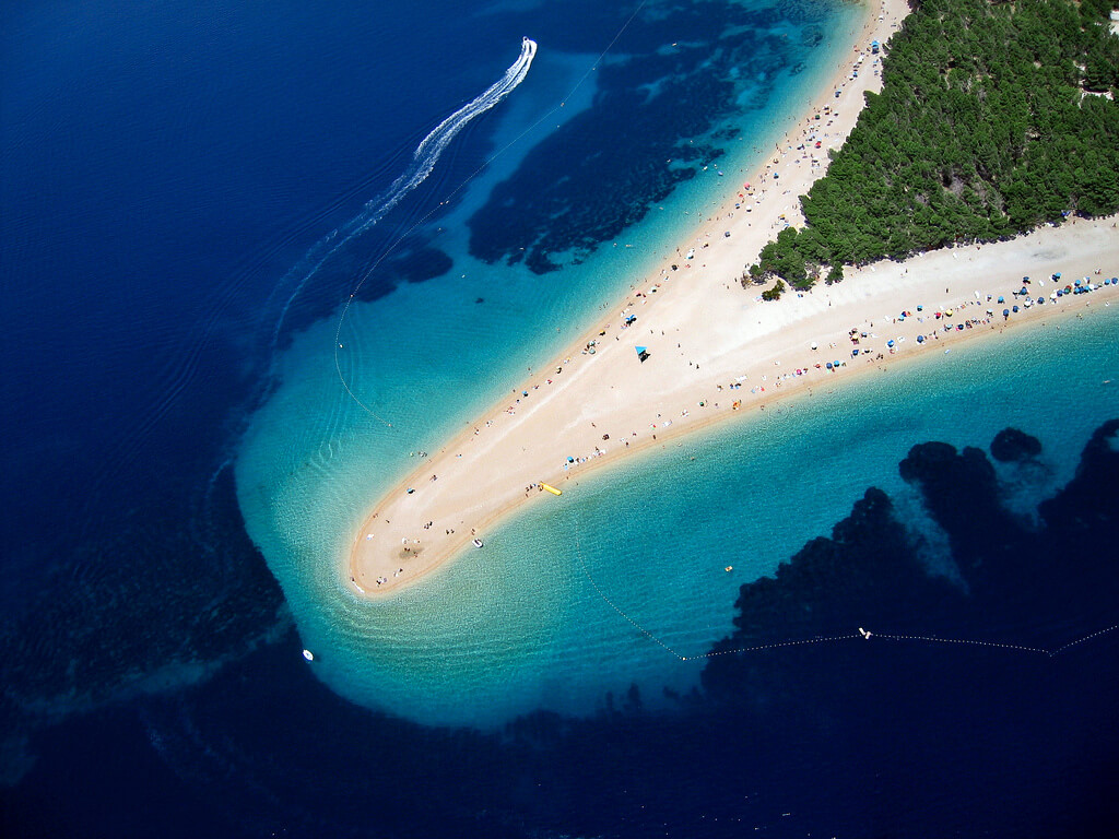 Aerial view of Zlatni Rat Beach in Bol on Brač Island with turquoise water and golden spit 