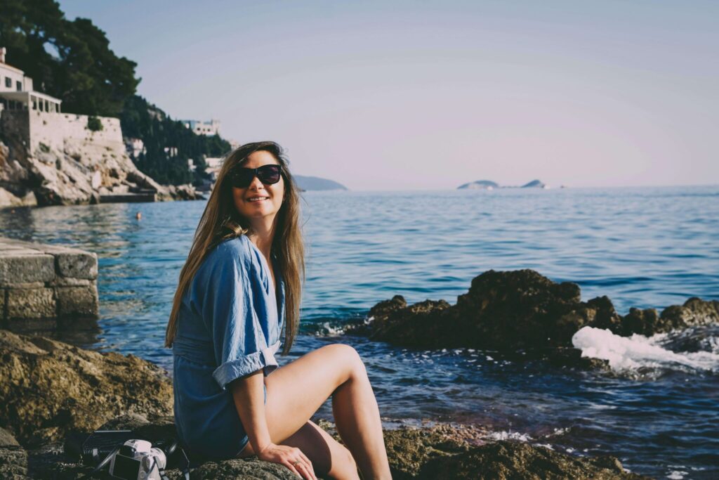 A woman on the rocky sea shore